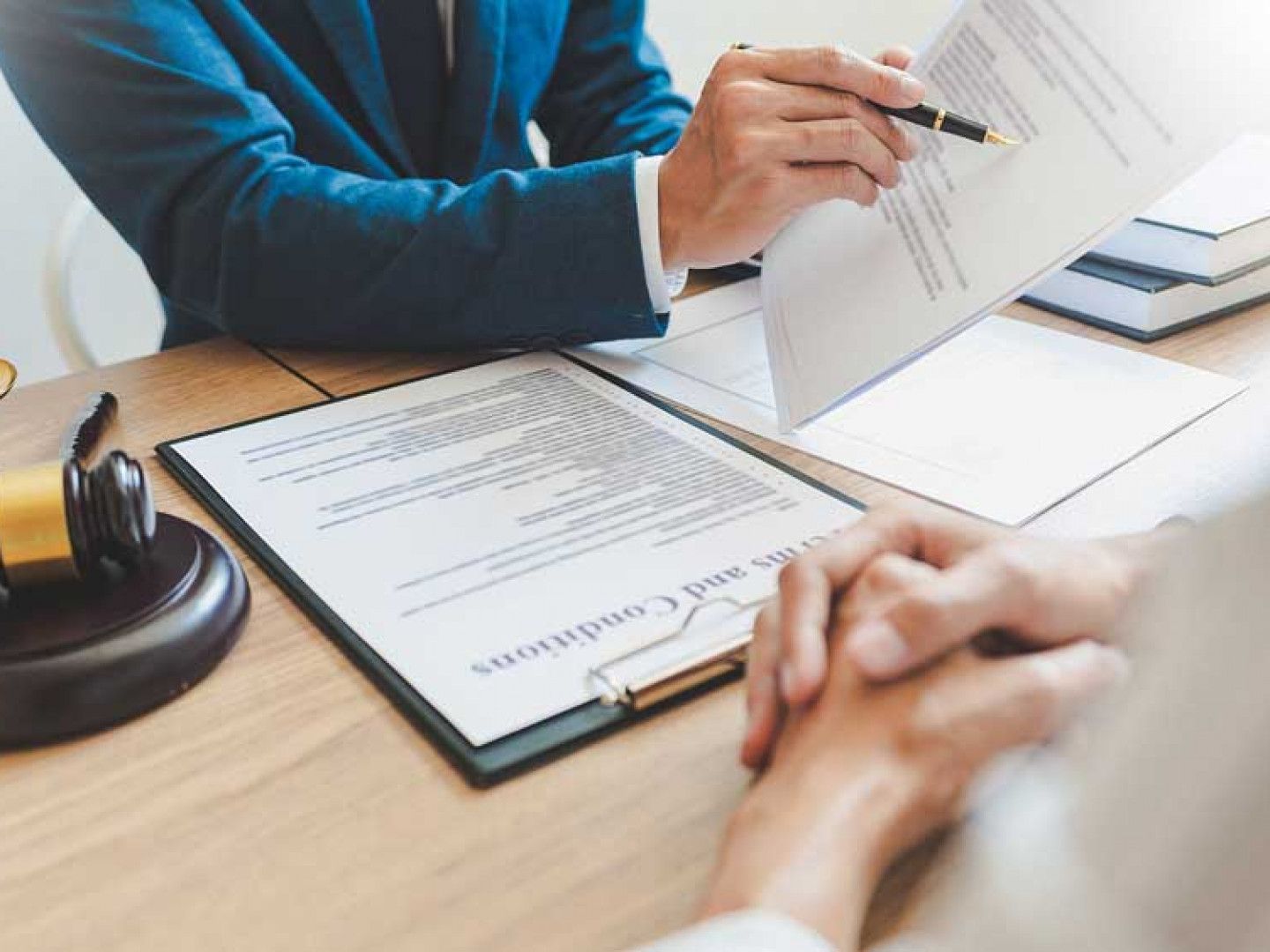 Legal professional reviewing employment law documents during a client consultation.  